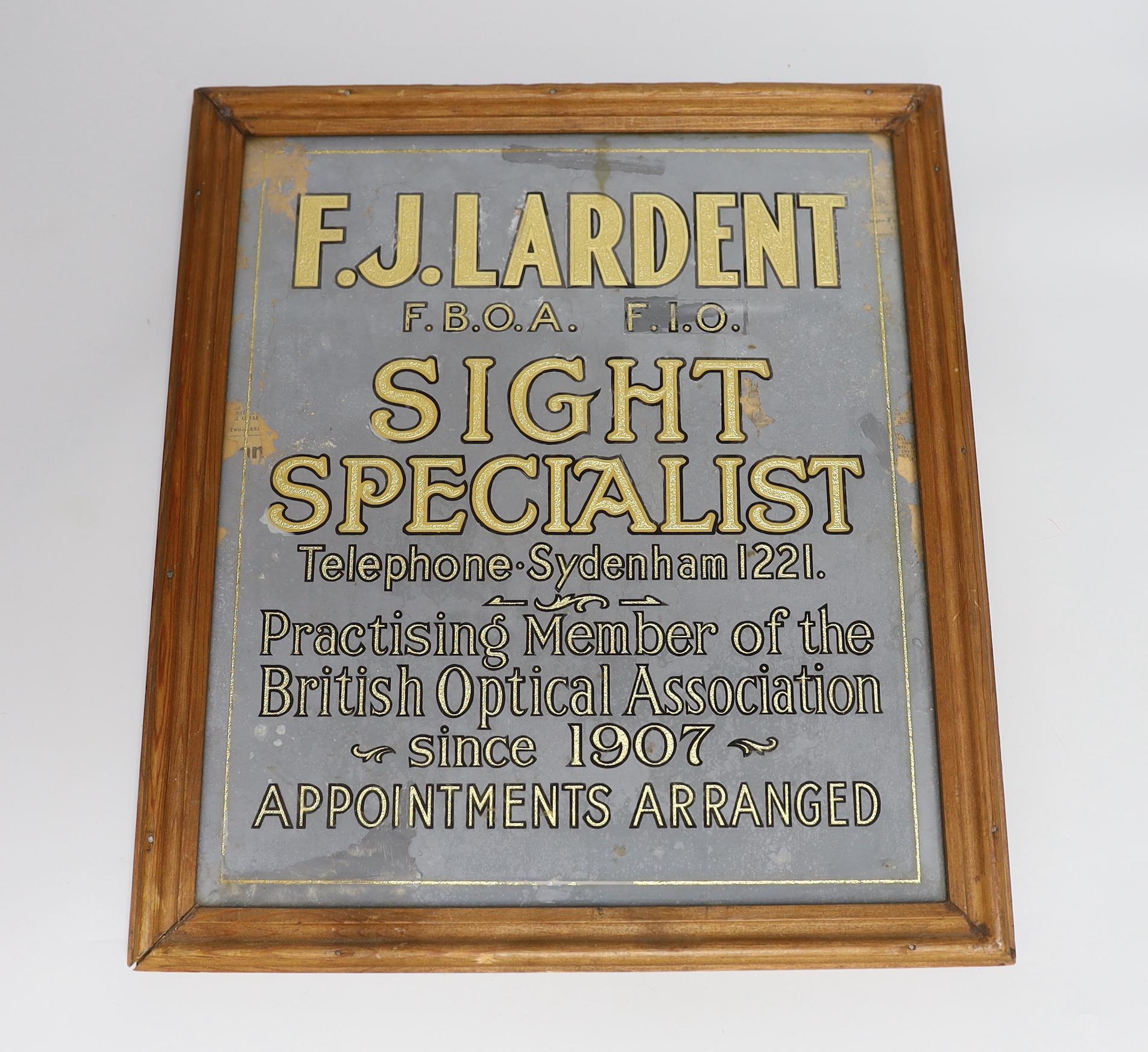 A framed F.J. Lardent Sight Speciality Sign and a jigsaw puzzle